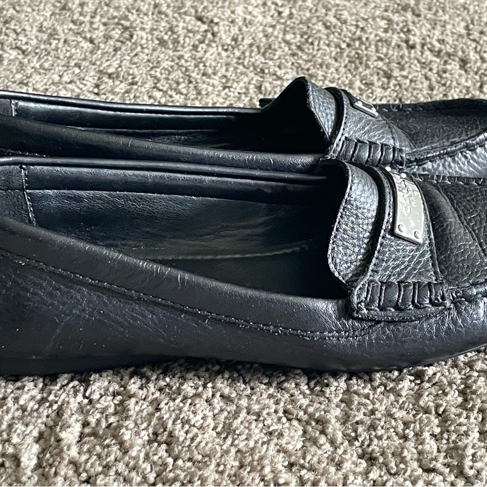 Coach black soft leather flat loafers.